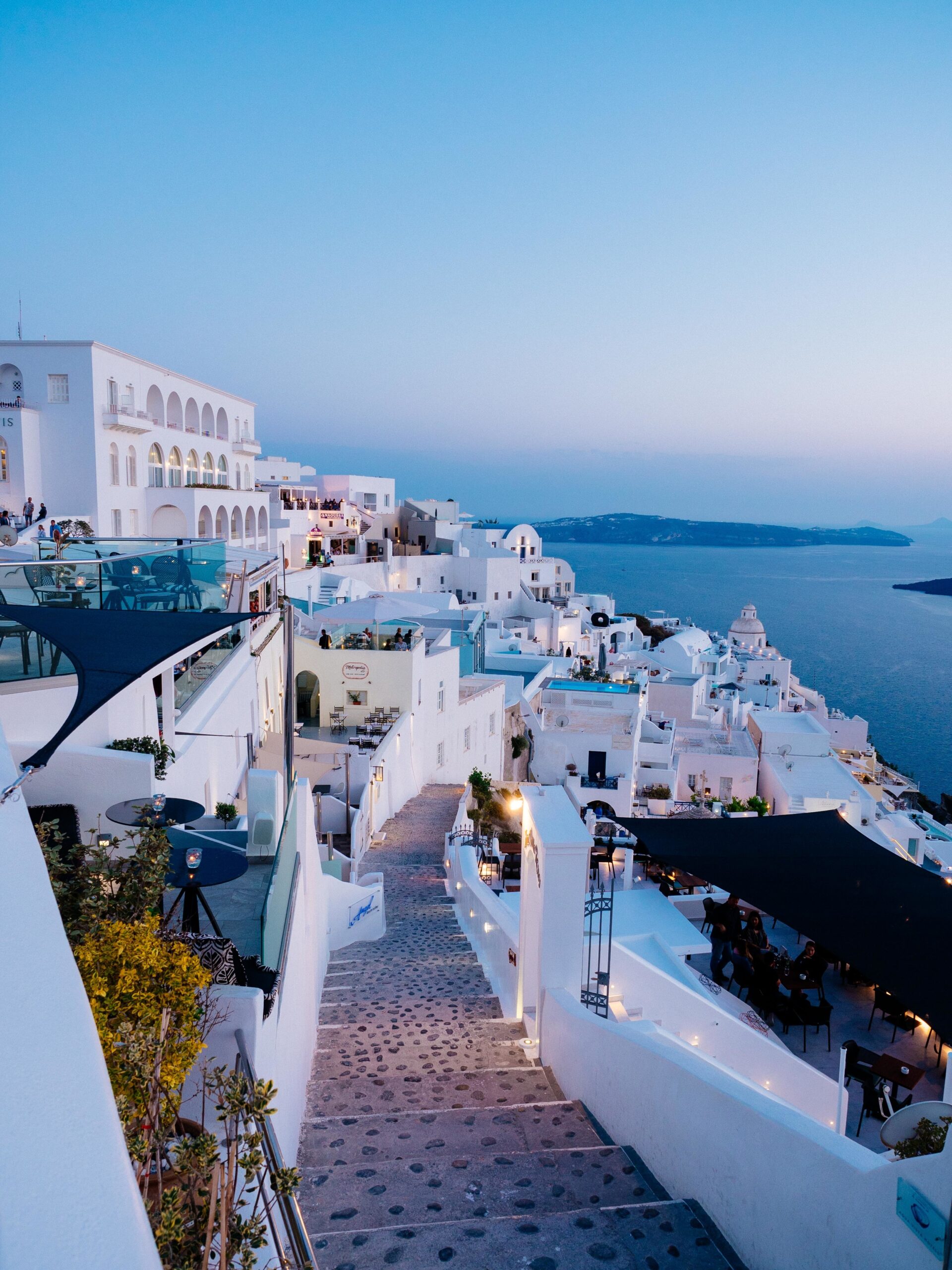 KayLux Travel, Vertical high angle shot of the white buildings in Santorini