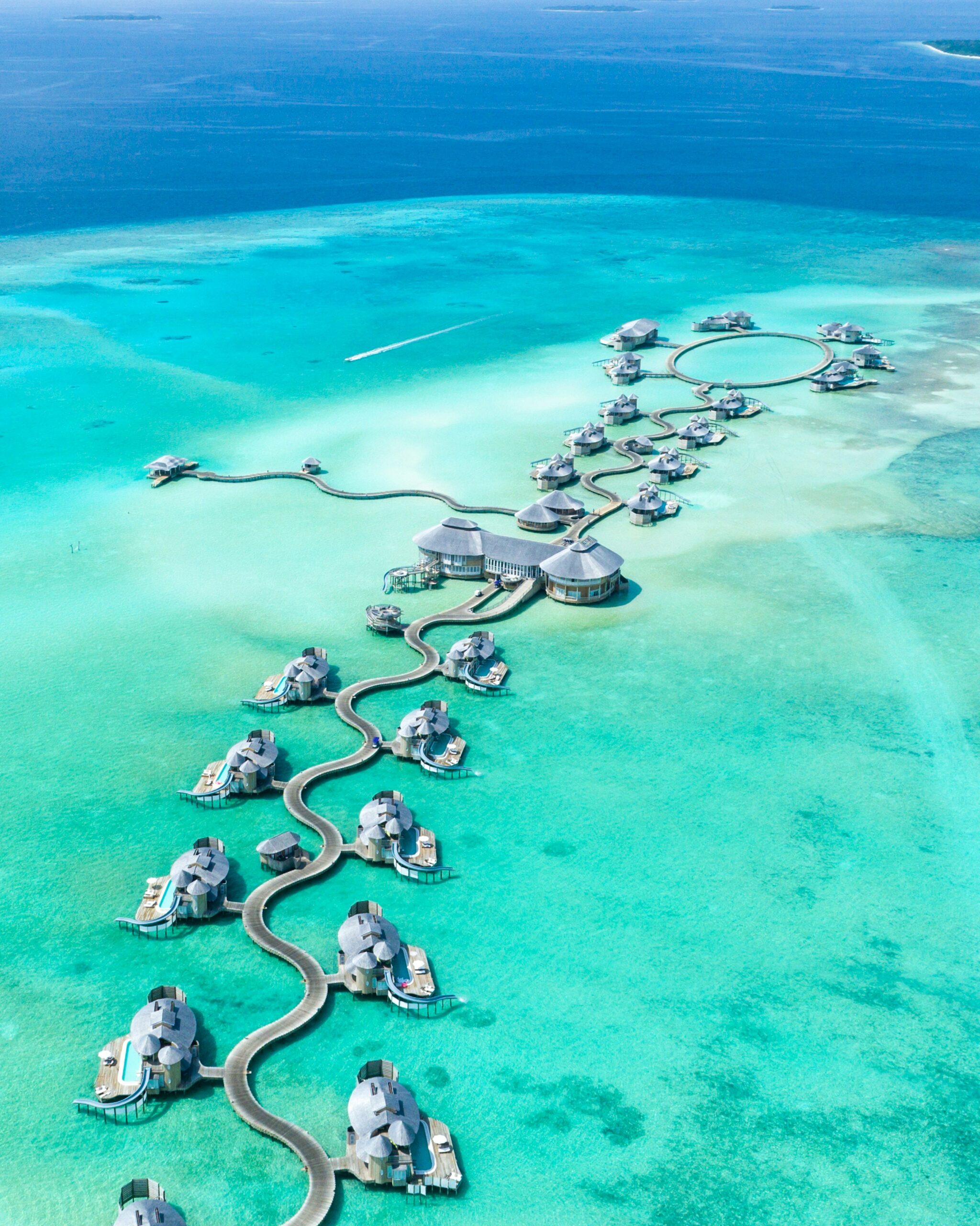 Overwater villas above the turquoise lagoon of the Maldives